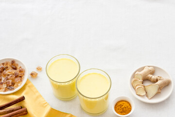 Yellow turmeric latte coffee. Golden milk with turmeric and cinnamon