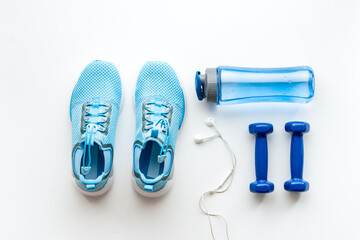Sneakers and dumbbells for workout sport flatlay background