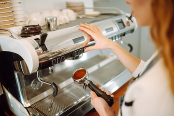 Female barista making coffee in coffee shop counter. Takeaway food.