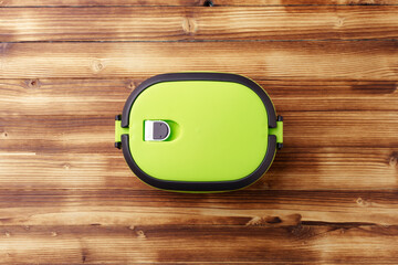 New empty plastic lunch box on a wooden background