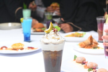a glass of juice alpukat coffee syrup on a white cloth.