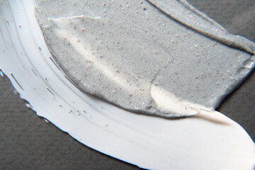 Close-up smear of creamy cosmetic and product with particles