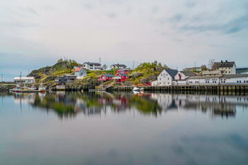 Fototapeta na wymiar Typical Norwegian colored houses at Reine village in Lofoten, Norway, during spring on a clear day with clouds