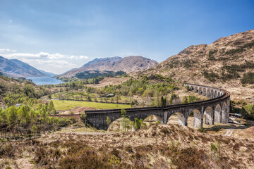 Famous Glenfinnan Railway Viaduct with beautiful countryside in Scotland, UK