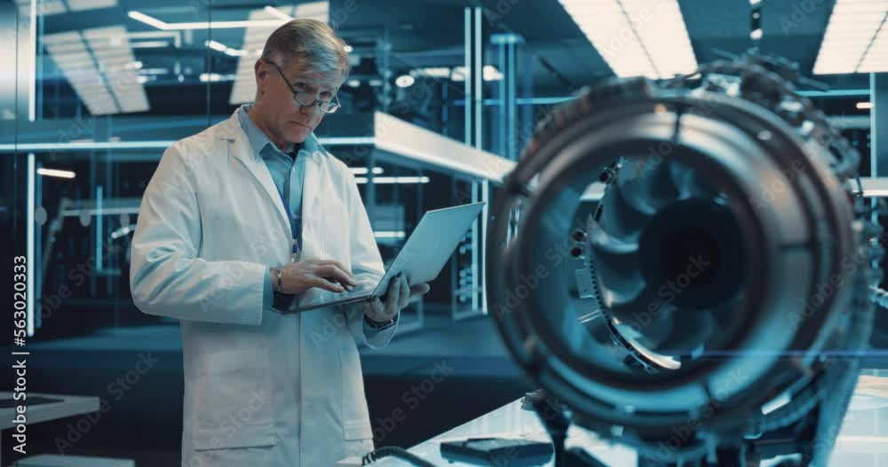 Poster adult chief engineer using laptop computer, analyzing and researching how a futuristic turbofan moto