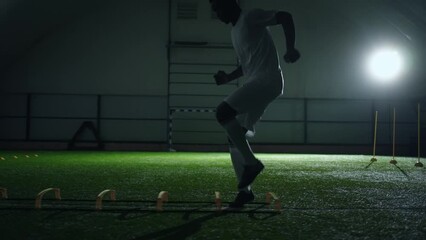 african american man training endurance and fast run, running and jumping over barrier indoors