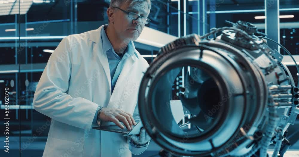 Poster adult chief engineer using laptop computer, analyzing and researching how a futuristic turbofan moto