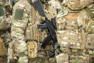 Army soldier with a machine gun in his hand. Soldier, commando standing, ready for combat training....