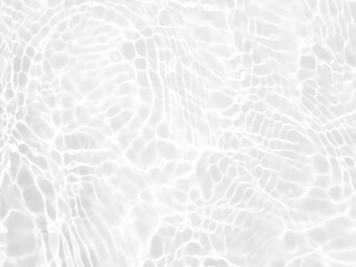 Defocus blurred transparent white colored clear calm water surface texture with splashes and bubbles. Trendy abstract nature background. Water waves in sunlight with copy space. White water shine
