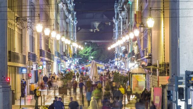 Crowded Augusta Street seen through the Triumphal Arch night timelapse connecting the most famous Lisbon street to Terreiro do Paco Square aka Praca do Comercio.