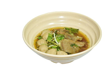 boiled braised beef and meatball in black herb soup on bowl