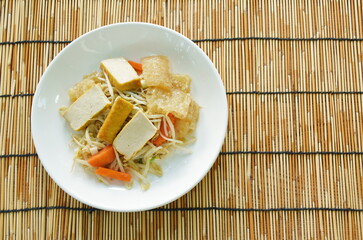 fried bean sprout with slice yellow tofu and pork skin on plate 