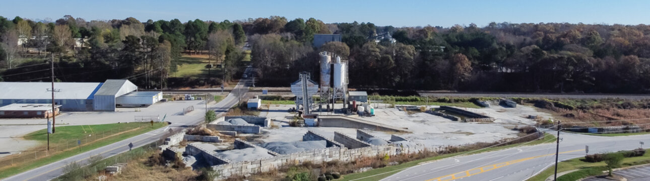 Panorama aerial ready-mixed concrete batching plant with cement silo, weigh hopper, conveyors, screw feeder and aggregates granular gravel, crushed stone