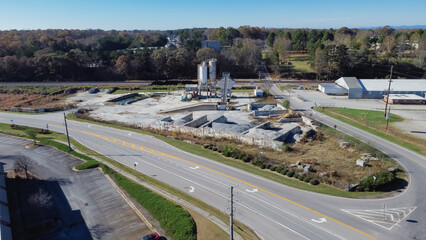 Aerial view ready-mixed concrete batching plant with cement silo, weigh hopper, conveyors, screw...