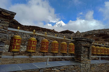Prayer drums are the part of the Buddhist culture. Prayer drums are rotated by hands.