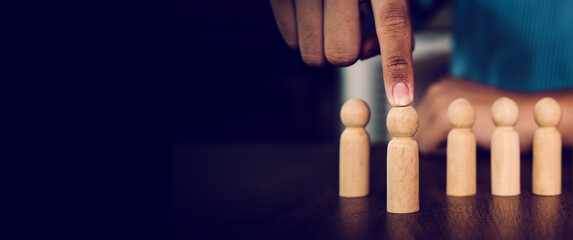 Hand choose wooden doll stand out first the group concept of relationship or HR human resources...