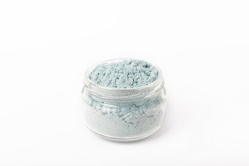 Blue spirulina powder in glass jar isolated on white background. Natural vegan superfood. Food supplement. Phycocyanin extract.