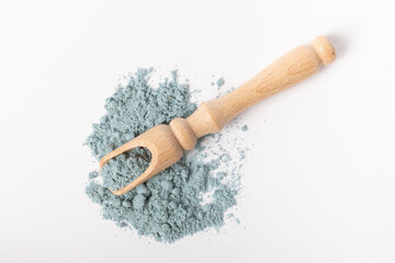 Fototapeta na wymiar Blue spirulina powder in wooden spoon isolated on white background. Natural vegan superfood. Food supplement. Phycocyanin extract.