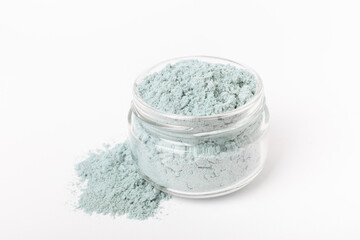 Blue spirulina powder in glass jar isolated on white background. Natural vegan superfood. Food supplement. Phycocyanin extract.