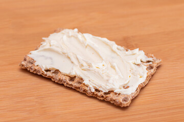 Whole Grain Crispbread with Cream Cheese on Bamboo Cutting Board. Quick and Healthy Sandwiches. Healthy Dietary Snack