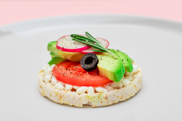 Rice Cake Sandwich with Avocado, Tomato, Cottage Cheese, Olives and Radish on White Plate. Easy Breakfast. Diet Food. Quick and Healthy Sandwiches. Crispbread with Tasty Filling. Healthy Dietary Snack