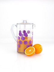 Pitcher with orange juice and fruits