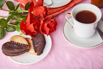 Red roses aesthetic, romantic St Valentines cookies, coffee cup. Lagom pink holiday background