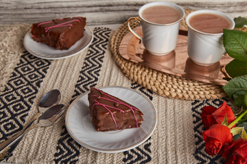 Aesthetic breakfast with chocolate cherry cake pieces, coffee cups, red roses - St Valentines day