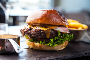Chicken burger with avocado and 2 cheeses. Delicious healthy traditional food closeup served for lunch in modern gourmet cuisine restaurant