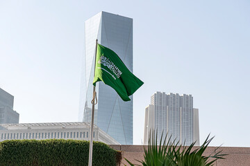 flag of Saudi Arabia against the background of tall building,
