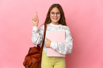 Student little girl over isolated pink background pointing up a great idea