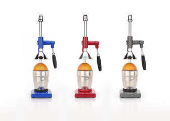 Juice maker, orange squeezers in different colors and oranges