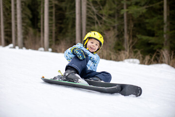 Fototapeta na wymiar Little toddler boy, preschool child, skiing for the first time