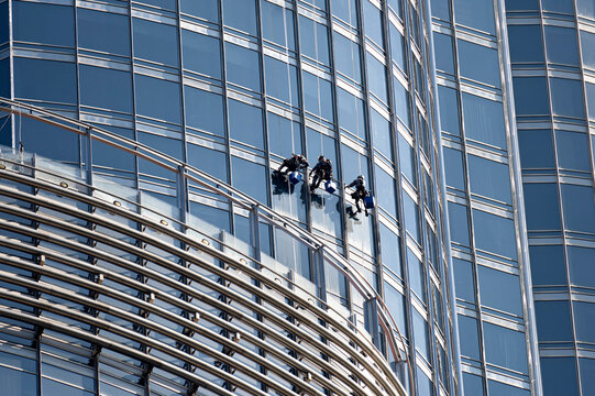 industrial climbers wash the windows of skyscraper at altitude