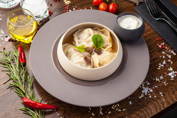 Black Angus beef hand-made dumplings. Cucumber-julienne with chilli-garlic butter and sour cream. Delicious healthy traditional food closeup served for lunch in modern gourmet cuisine restaurant