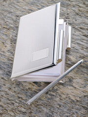 silver notebook on stone background