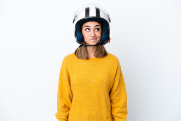 Young caucasian woman with a motorcycle helmet isolated on white background and looking up
