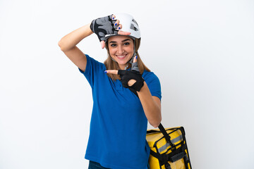 Young caucasian woman with thermal backpack isolated on white background focusing face. Framing symbol