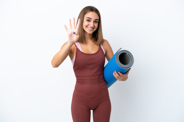 Young sport caucasian woman going to yoga classes isolated on white background happy and counting four with fingers