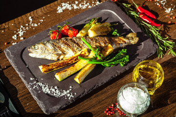 Rainbow trout grilled. Vegetables, white wine sauce. Delicious healthy traditional food closeup served for lunch in modern gourmet cuisine restaurant - 563040509