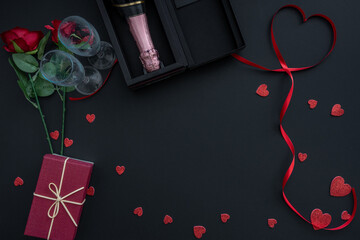 Beautiful valentines day background with red hearts, roses, gift box and champagne on black banner background. Wedding, birthday, Valentine's Day. 14 February. 