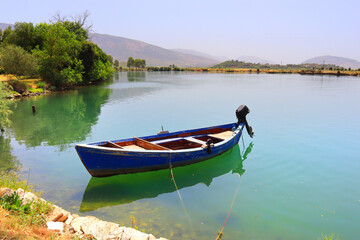 Naklejka na ściany i meble Butrint Lake with a boat in Butrint National Park, Buthrotum, Albania