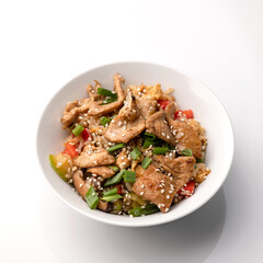 Udon noodles with chicken teriyaki, mushrooms, vegetables and sesame seeds. Asian cuisine. Dish on white background. Top view. 