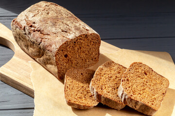 Bread with slices on parchment paper close up