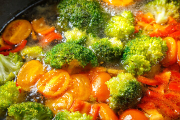 Stewed vegetables bright beans broccoli tomatoes stewed with spices close-up.