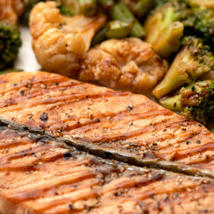 Grilled fish steak garnished with broccoli and cauliflower. Vegetarian food. Healthy food. Close-up. 