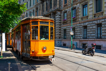 Old street with vintage tram in Milan, Italy. Architecture and landmarks of Milan. Cozy cityscape of Milan.