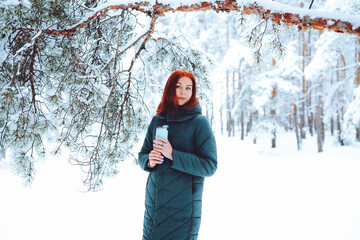 Young beautiful woman in winter forest