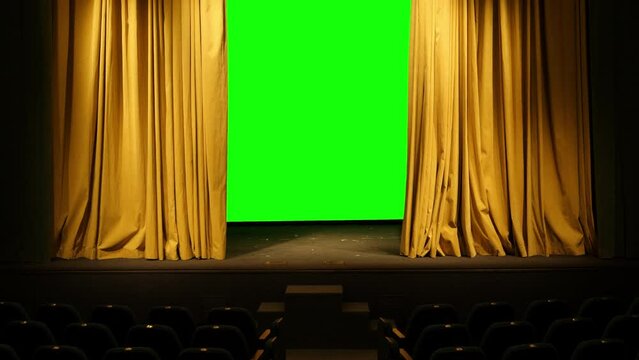 a juicy mustard-colored theatrical curtain in the auditorium moves to the side behind it a green background Overall plan