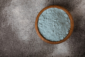 Blue Spirulina algae powder on black marble background. Diet and detox concept.Natural vegan superfood. Food supplement. Copy space. Place for text.